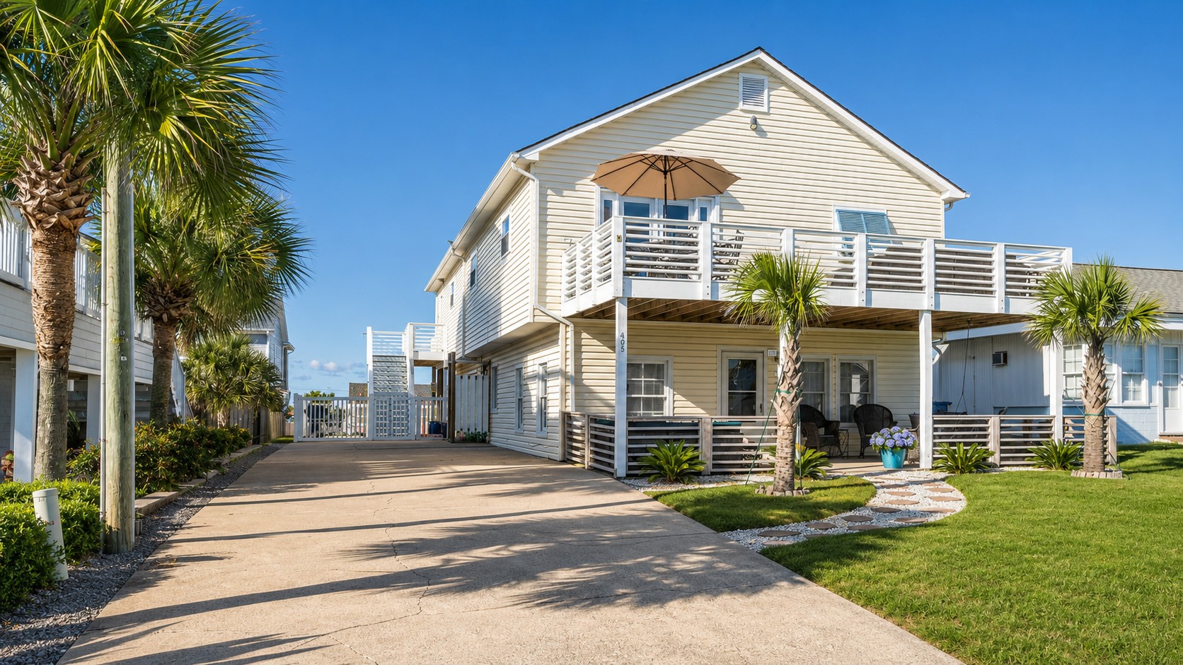 205 Barefoot Lane exterior with driveway and palm trees