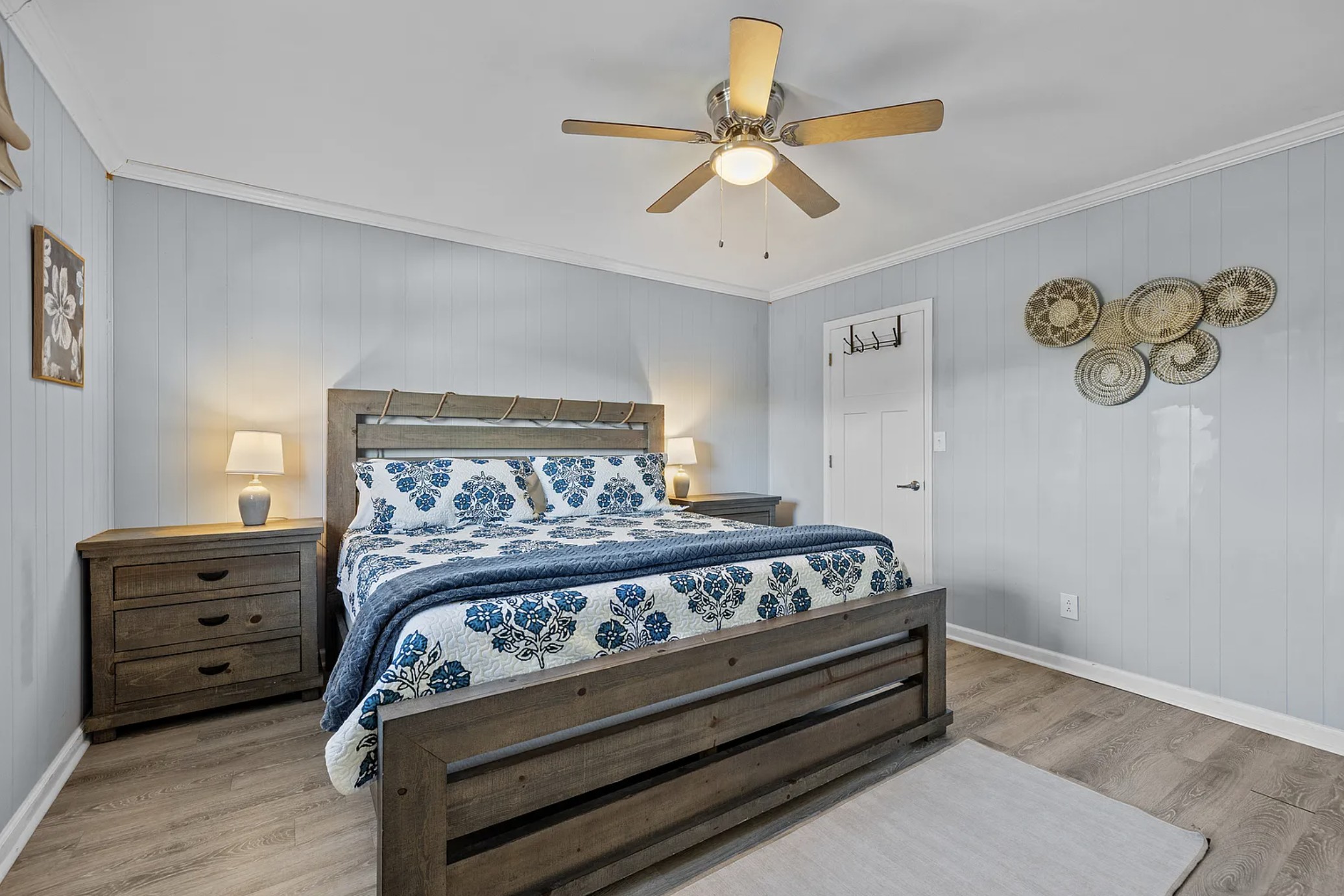 King bedroom with rope-accent headboard and woven wall baskets