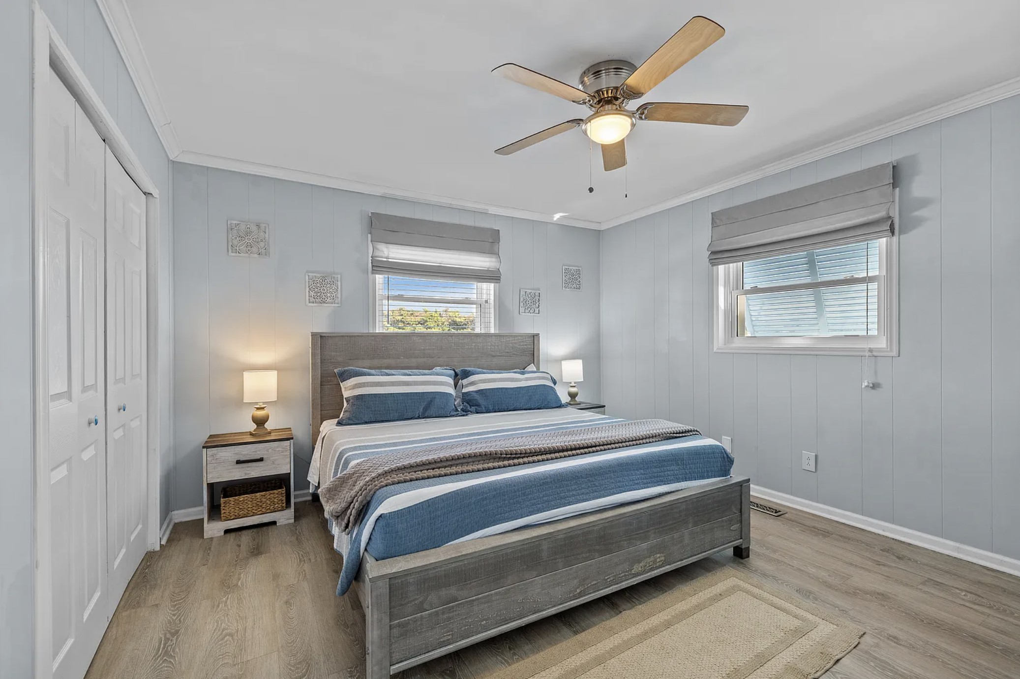 Second king bedroom with gray headboard and two windows
