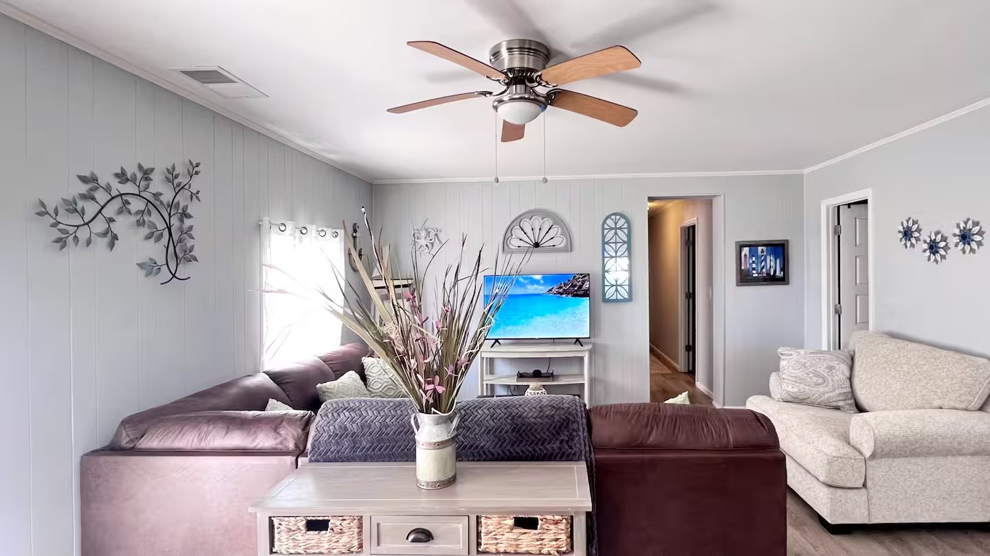 Living room seating area with sectional and mounted TV